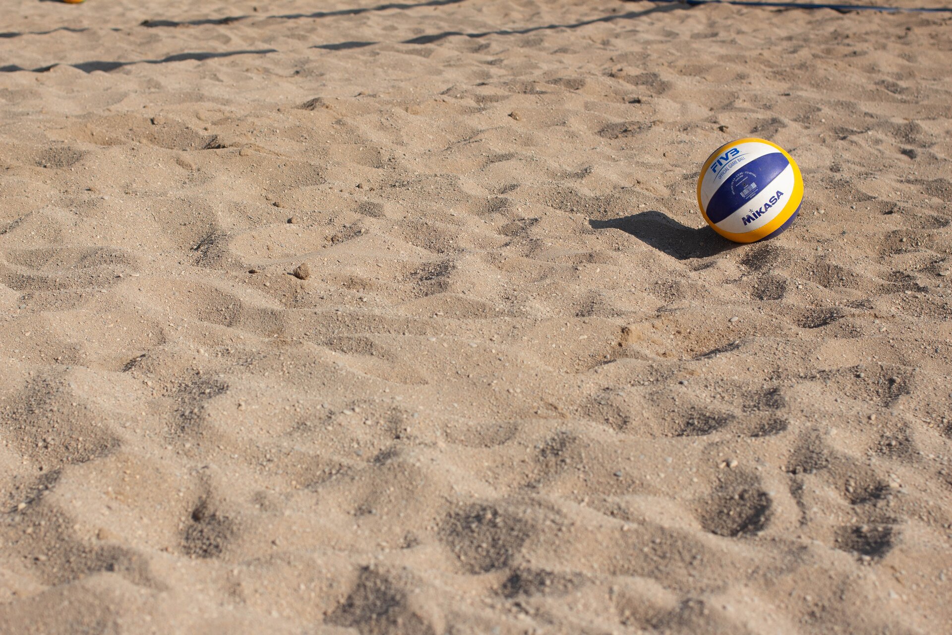 Beach volleyball on sand court.
