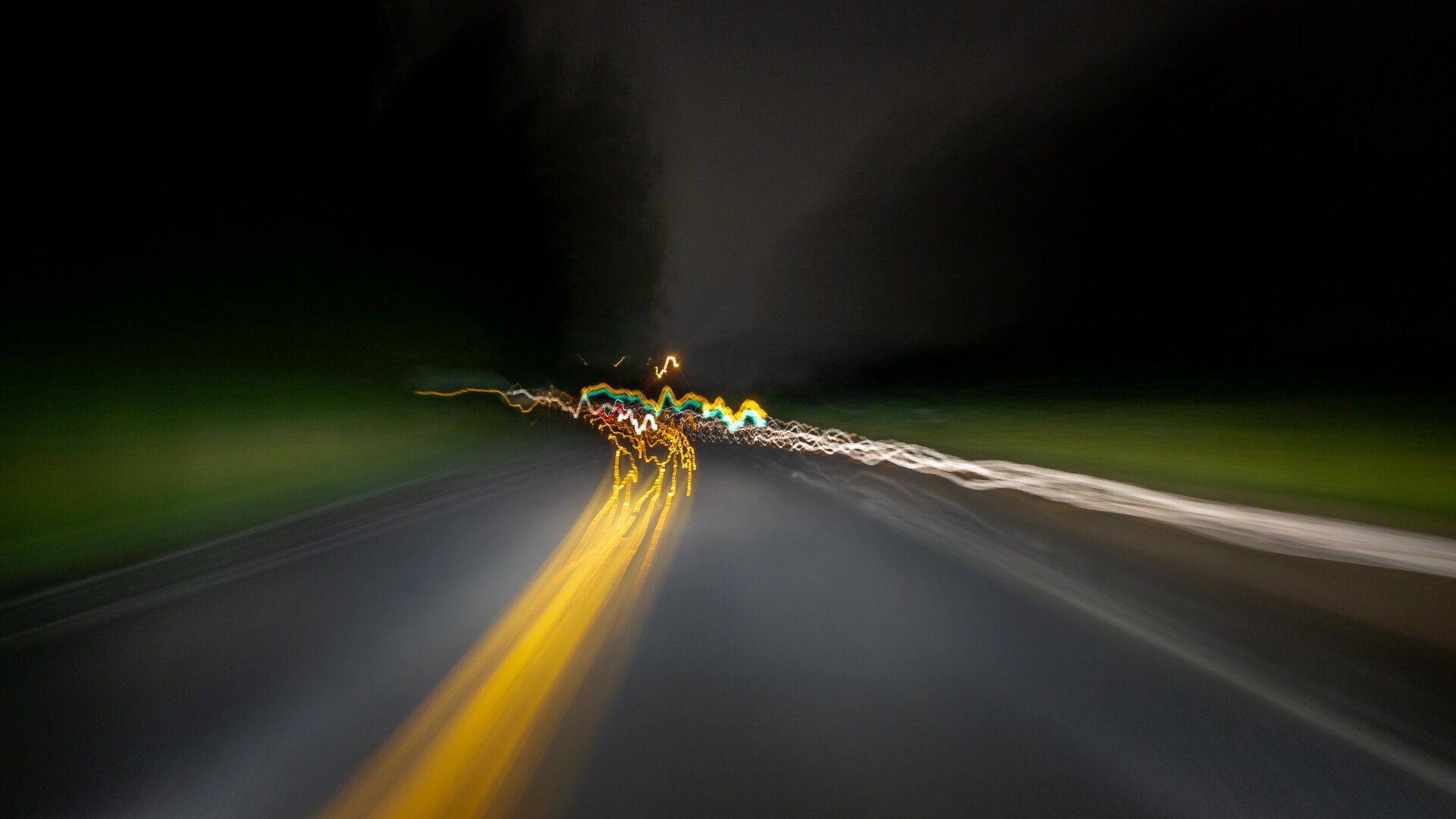 dark chaotic driving with yellow blurred road lines green sides