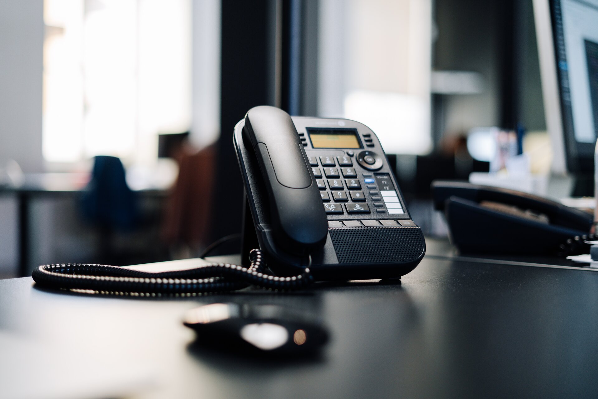 Phone on a black desk.