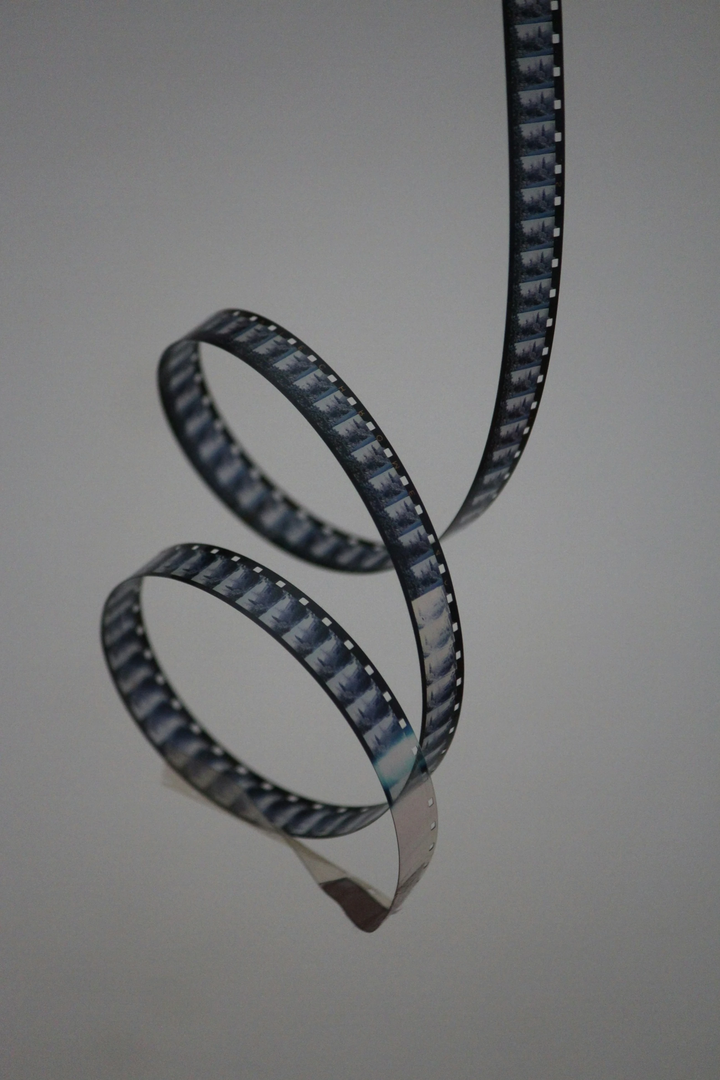 My grandpa made a lot of film when he was younger. This is a filmreel he shoot in 8mm around the year 1970 A old 8mm filmreel on a white background. | © Unsplash / Denise Jans