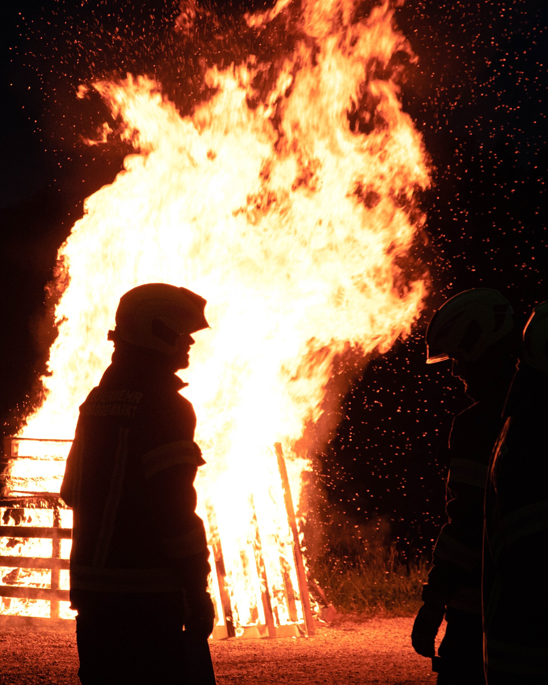 Firefighters in front of a huge fire.