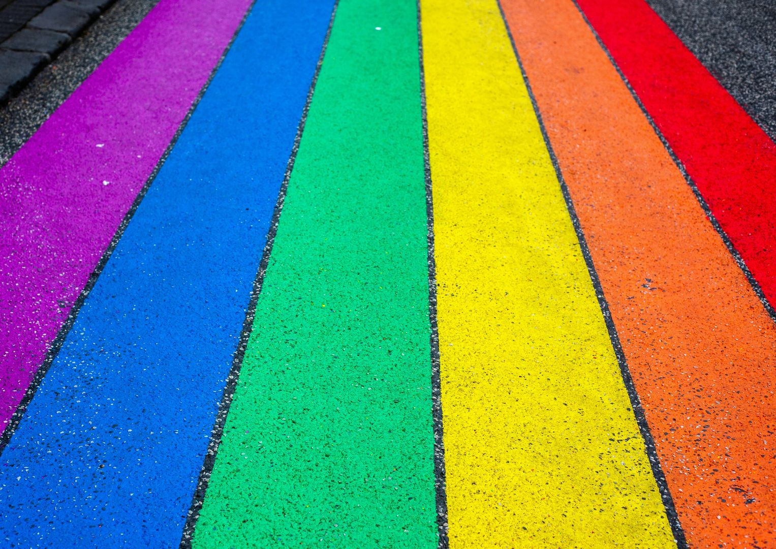 This photo of a rainbow painted on the street was taken in Reykjavik, Iceland, on 12. August 2018. 

My title is "Walking Proud". I have seen this photo is being used in the support of LGBTQ+ and diversity topics. Keep up the good work! | © Unsplash / Jas Min