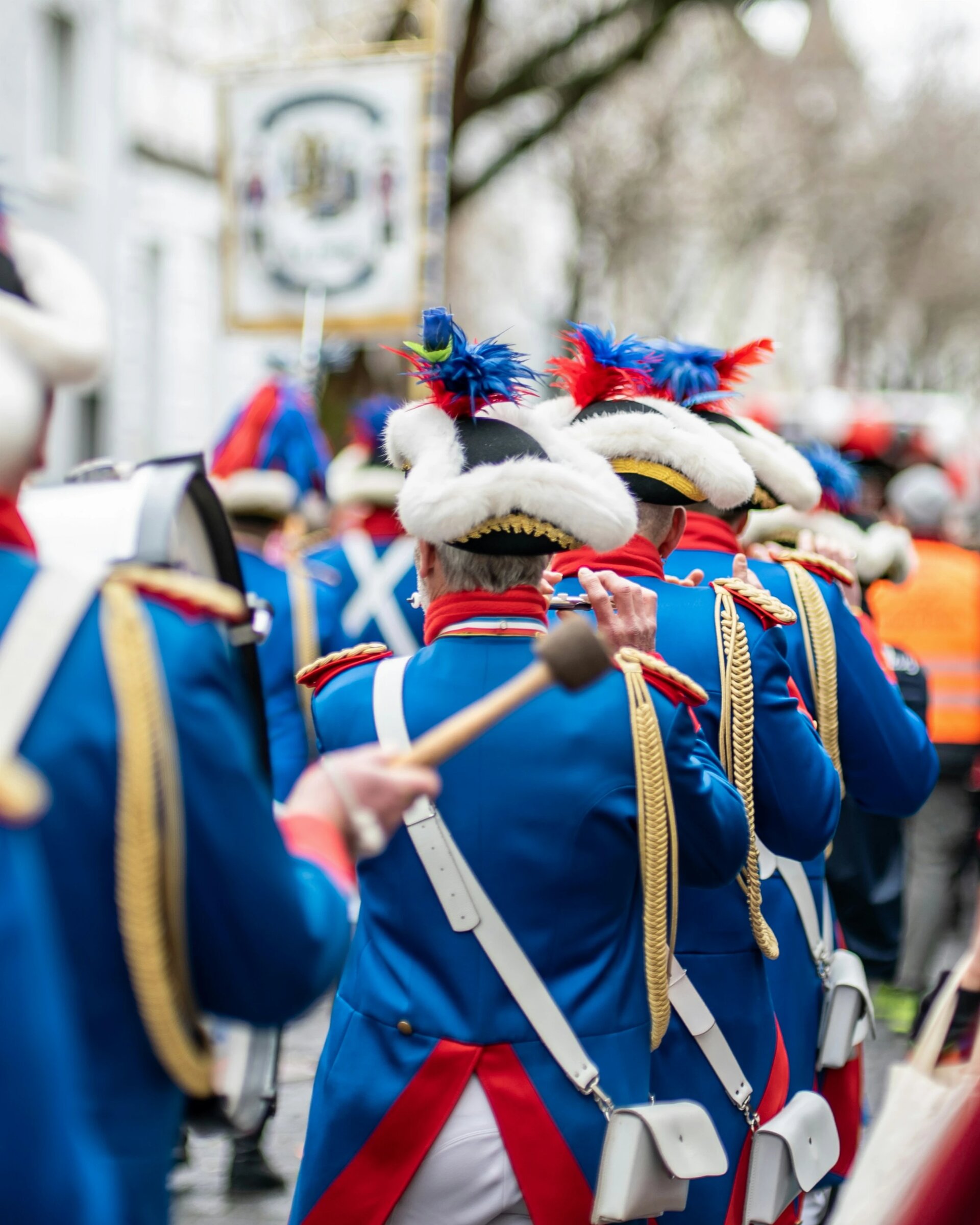 It's Karneval in Germany! everyone is dressed up, everyone is having fun. And theres a big difference to Brazilian Carnival :) 
You see a "Musikkapelle" (marching band) playing different flutes, drums and carillons.