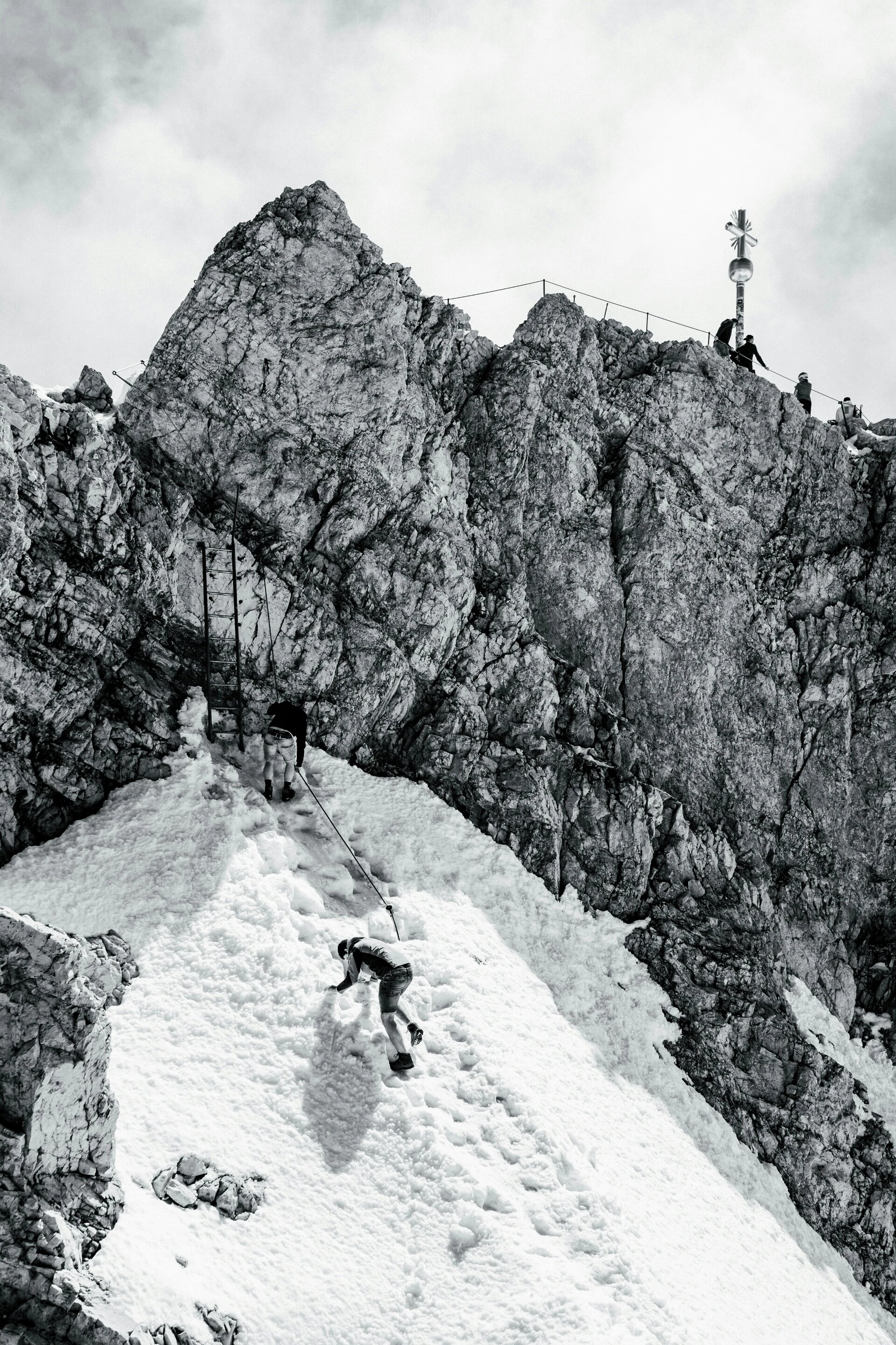 A guy climbs to the top of Zugspitze