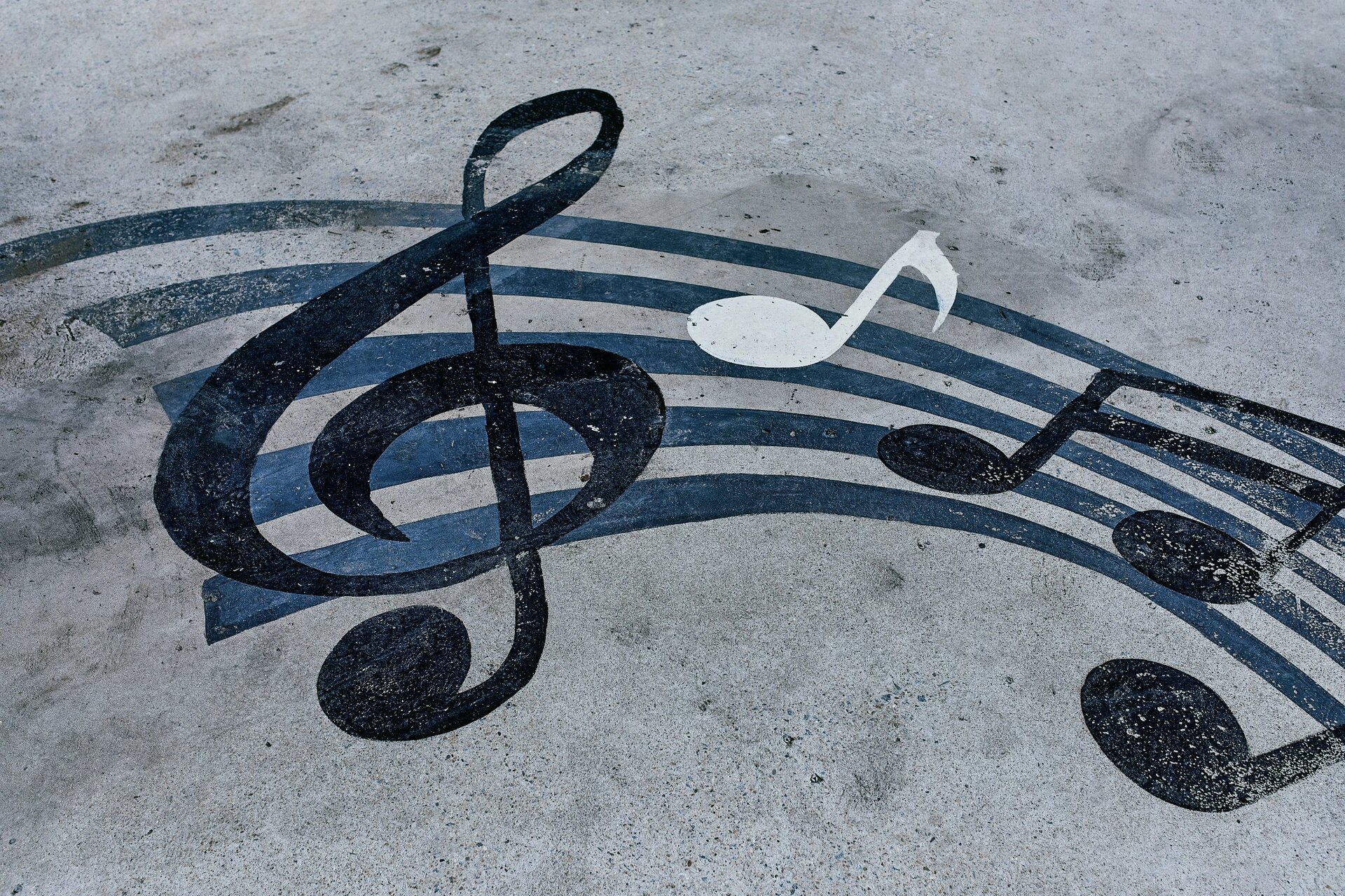 Notes drawn on a muddy road. Horizontal background with musical notes