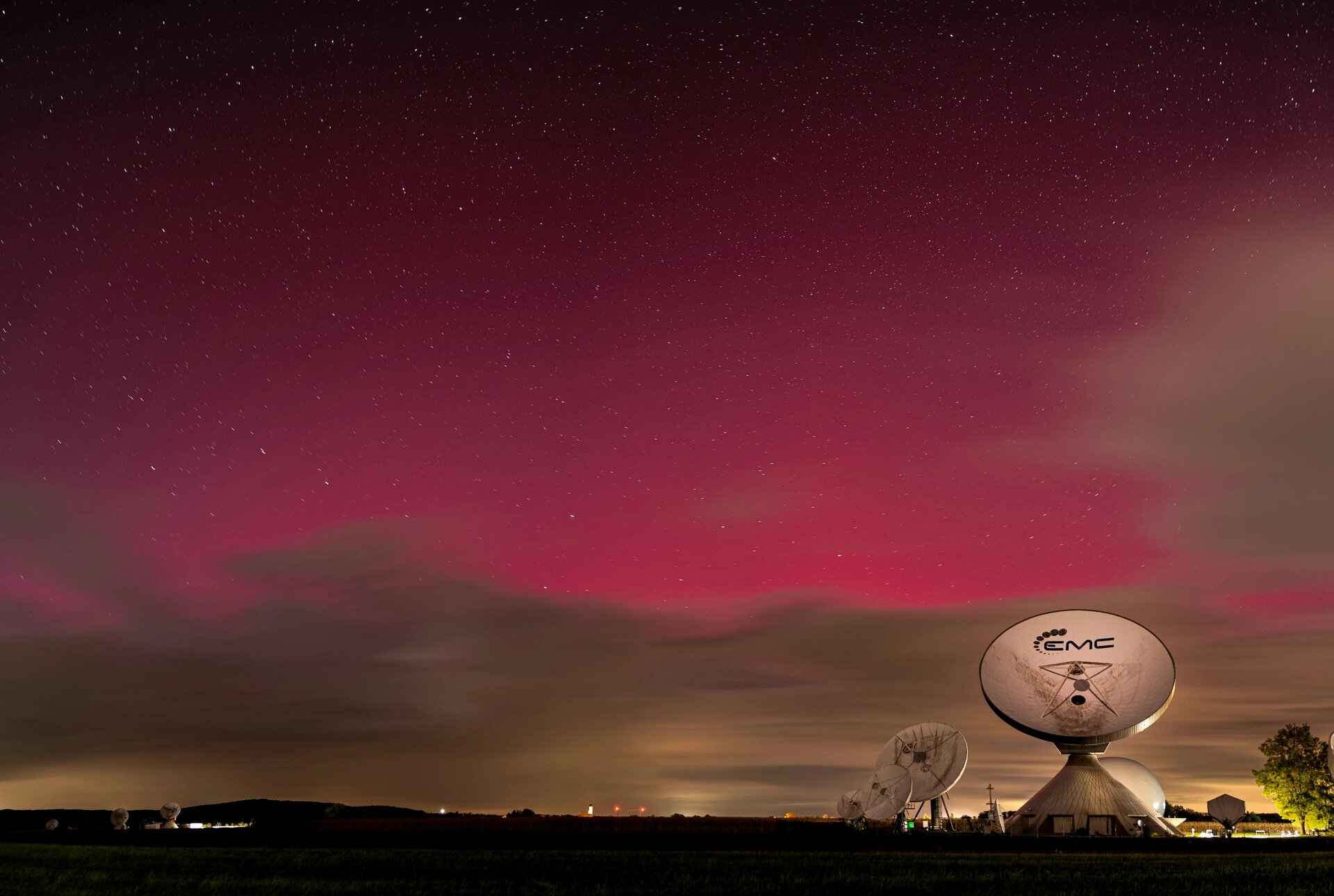 Northern lights in Germany. In the foreground the earth station in Raisting, Bavaria