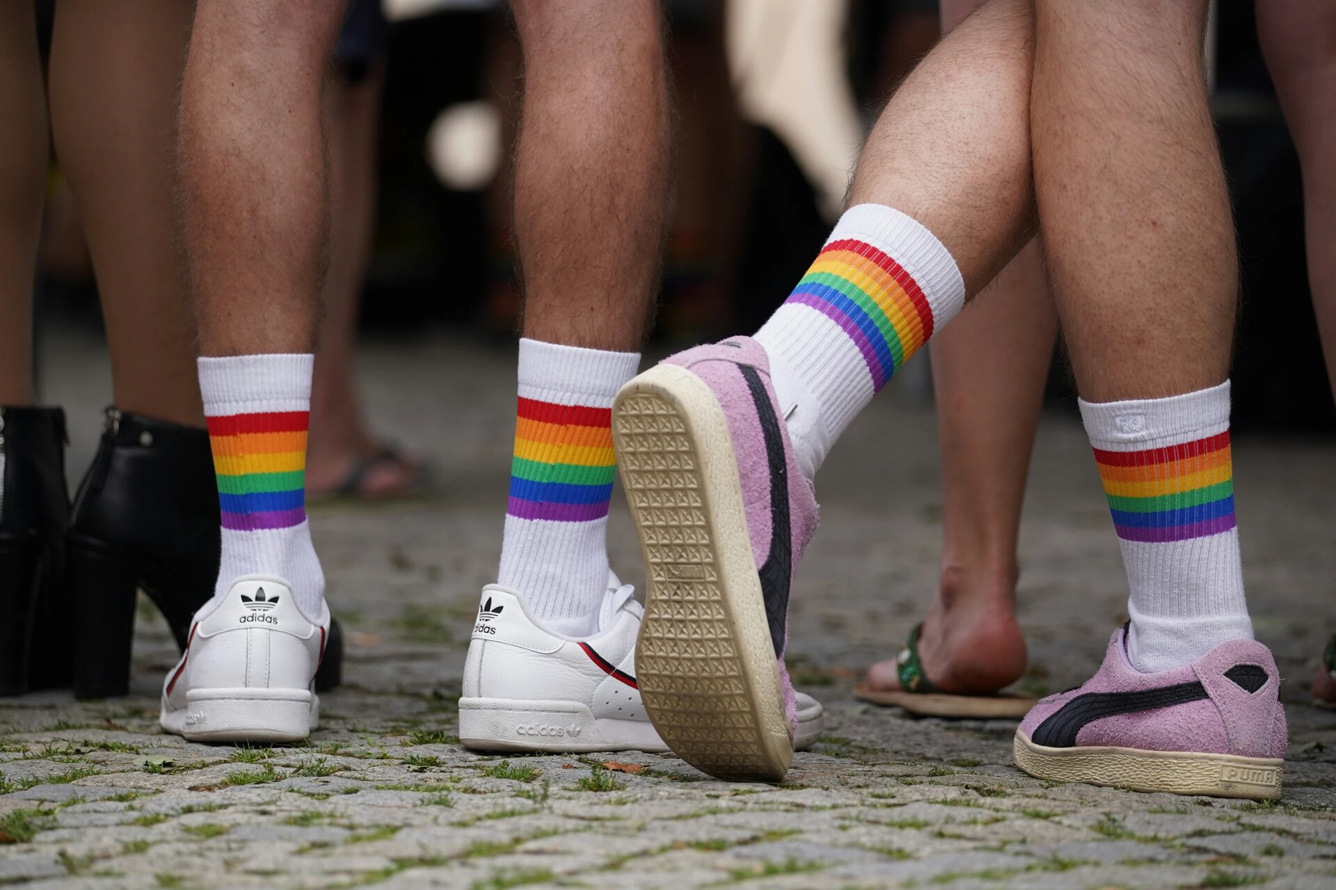 Two men with rainbow socks taking part in a CSD.