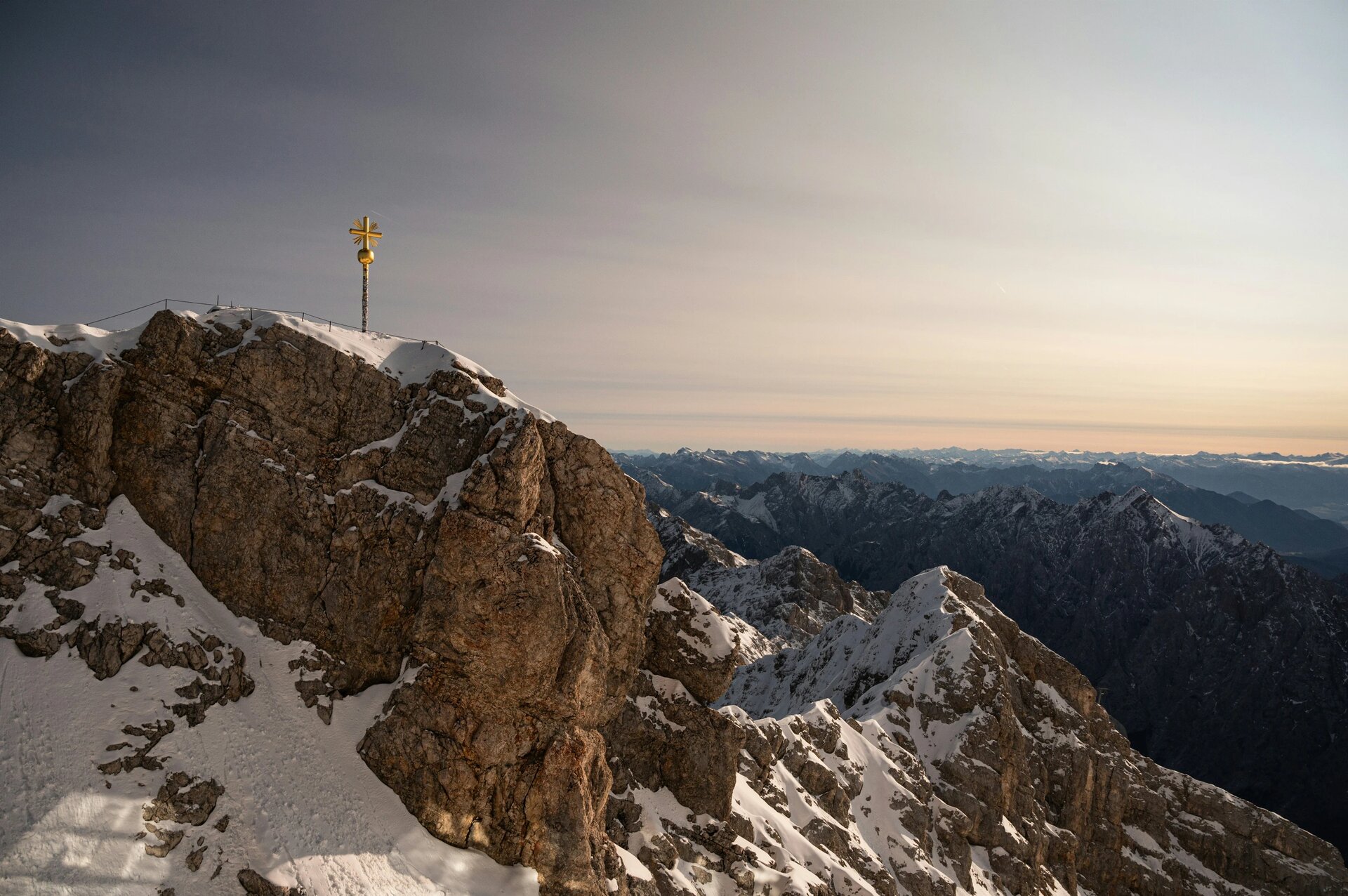The golden summit of Zugspitze with mountains in the back