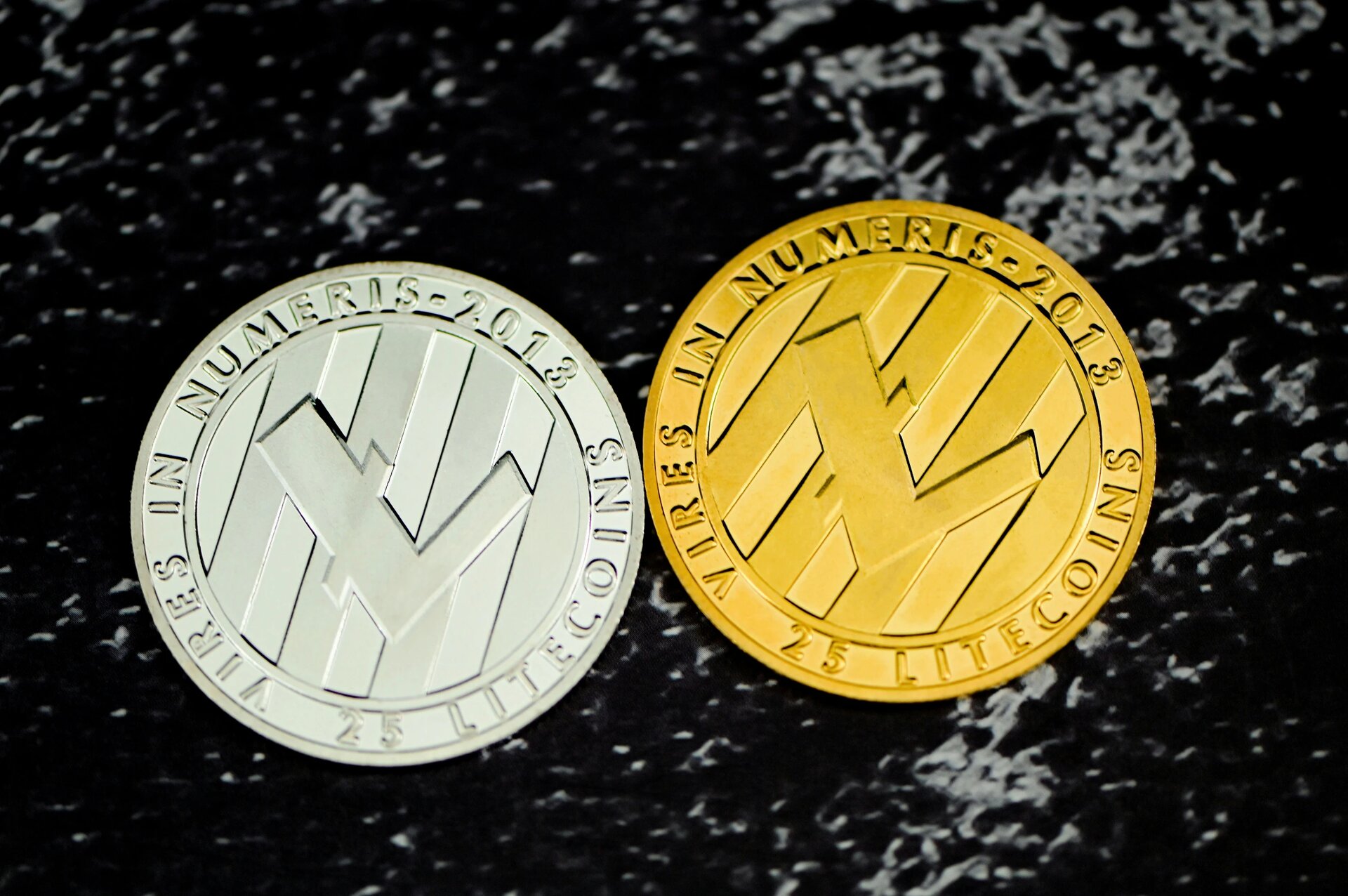 Silver and gold Litecoin placed next to each other