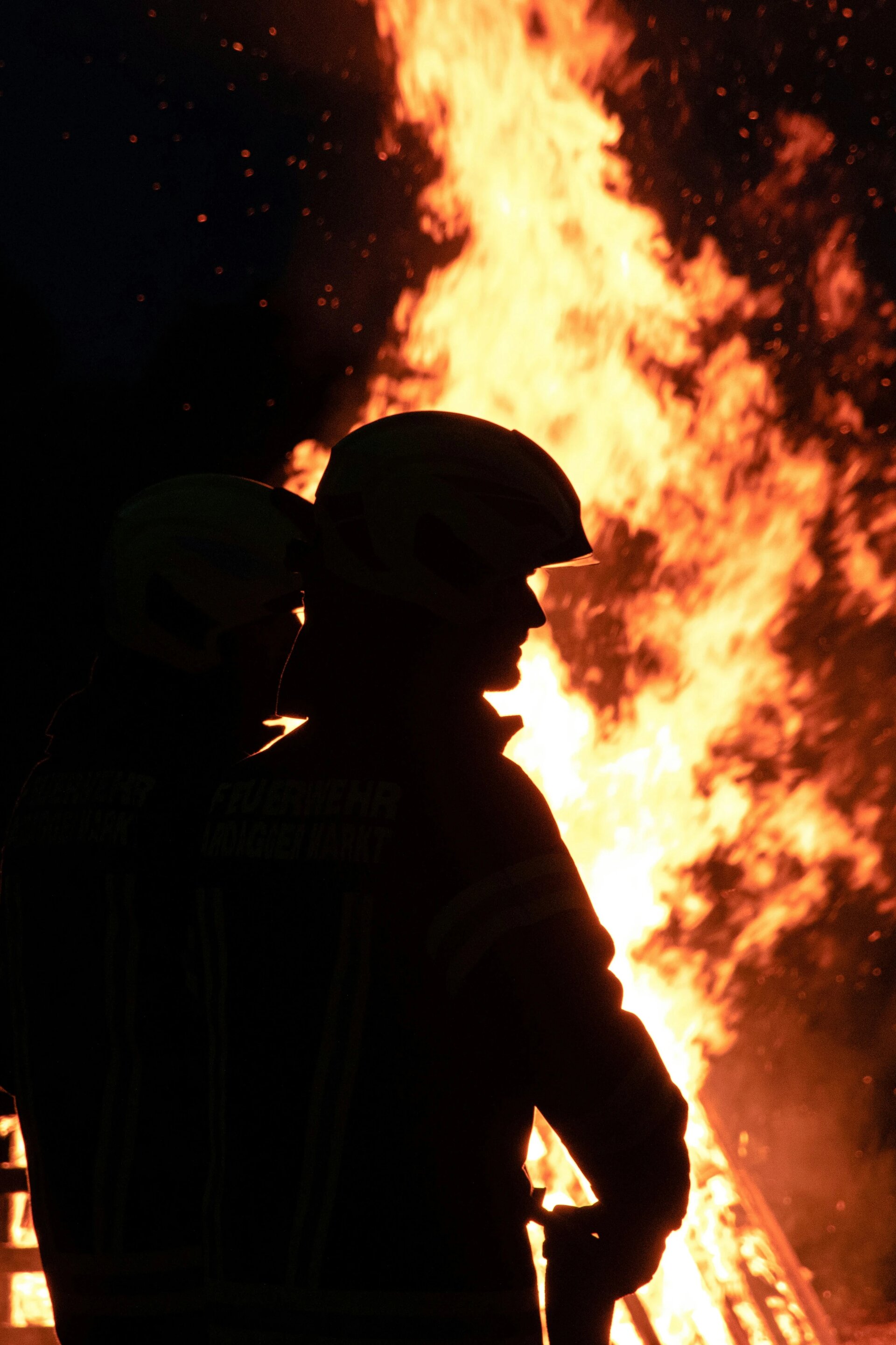 Firefighters in front of a huge fire.