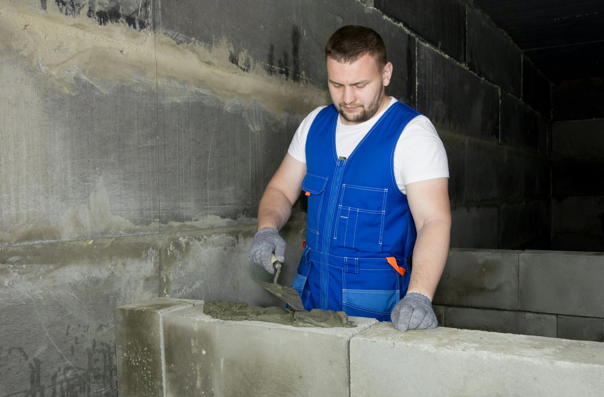 With the help of a cement solution, the worker builds a wall of foam blocks. More of my photos and videos Adobe Stock:http://bit.ly/3RqlciK More of my photos and videos Shutterstock: https://www.shutterstock.com/g/ALEKSANDRBERDYUGIN My email: bermix999@gmail.com
