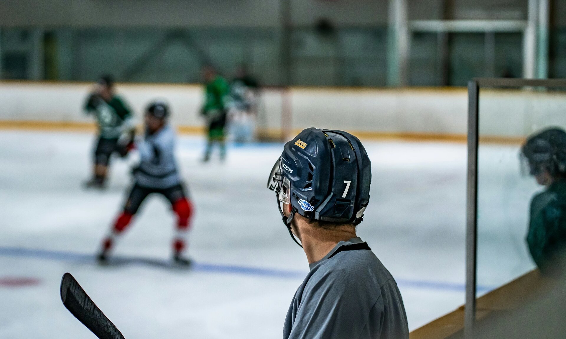 hockey player on the bench watching the action