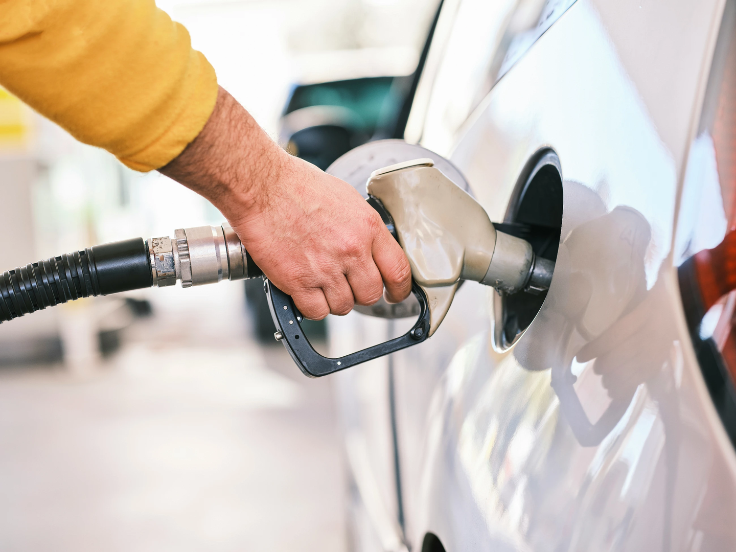 Pumping gas at gas pump. Closeup of man pumping gasoline fuel in car at gas station. | © Unsplash / engin akyurt