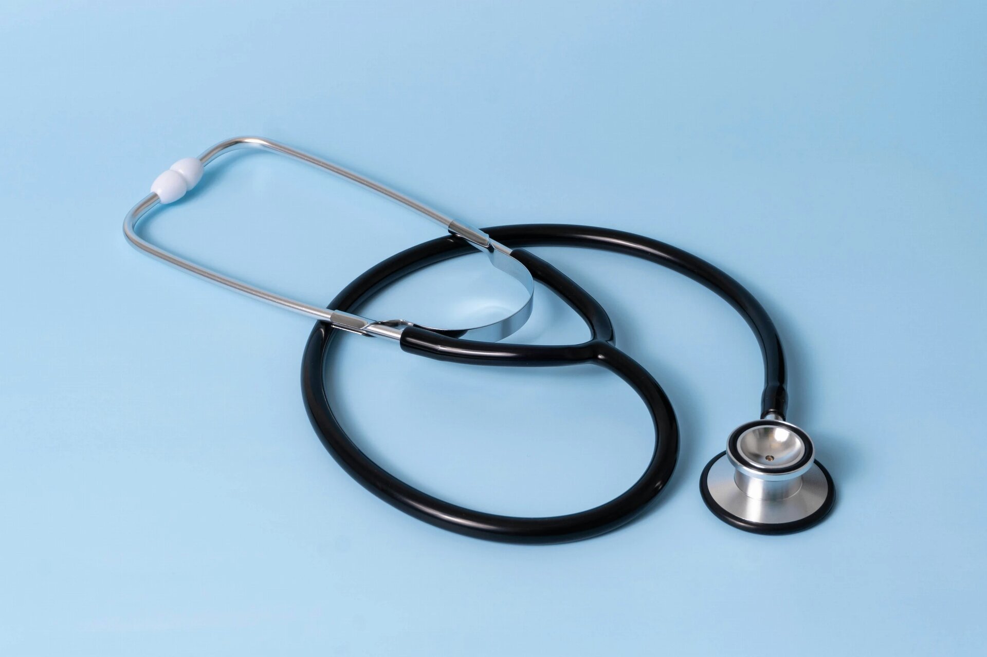 Stethoscope on a pastel blue background.
