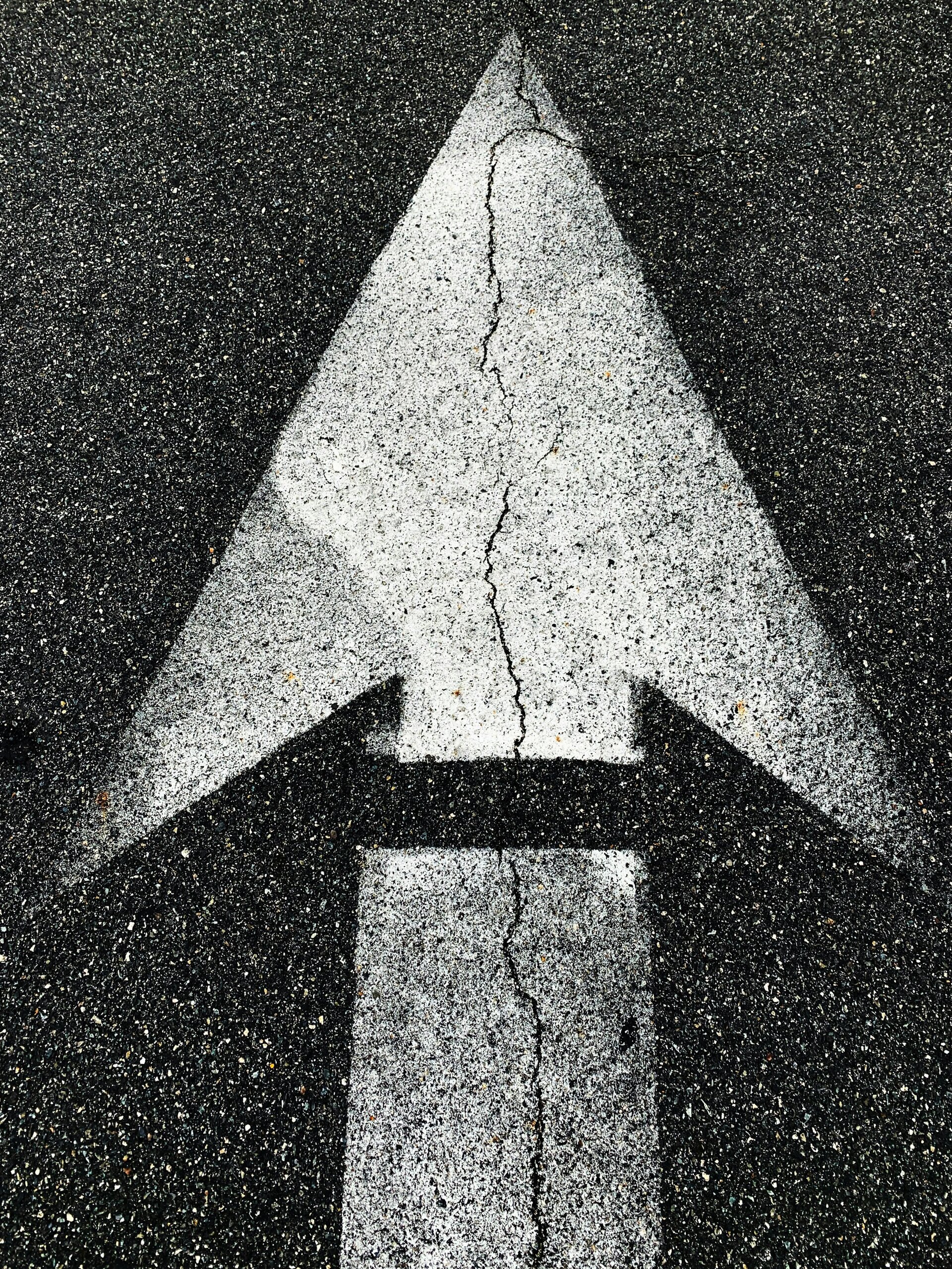 Painted arrow on paved road