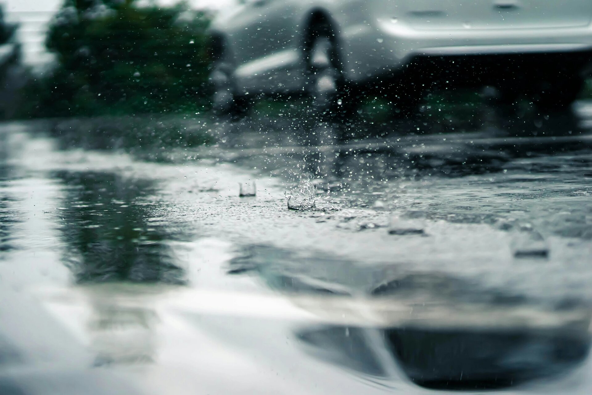 Water droplets hit the ground in a line as they fall from the roof of the Atlanta Botanical Gardens parking deck